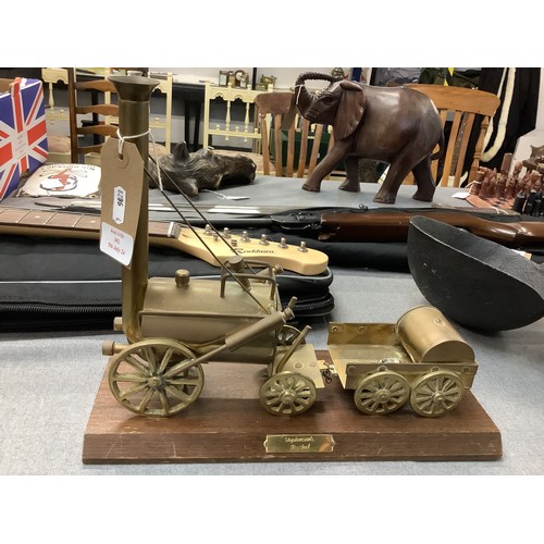 302 - A brass model of a Stephenson's rocket mounted on wooden base