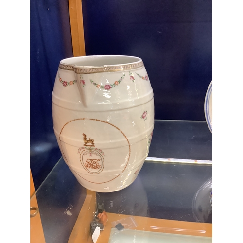 23 - An 18th C Chinese famille rose water jug decorated with a J M monogram below floral swags having twi... 