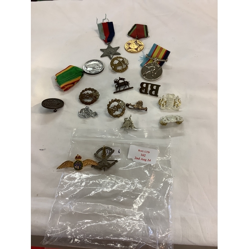 162 - A mixed selection of assorted badges and medals to include The 1939-1945 Star etc