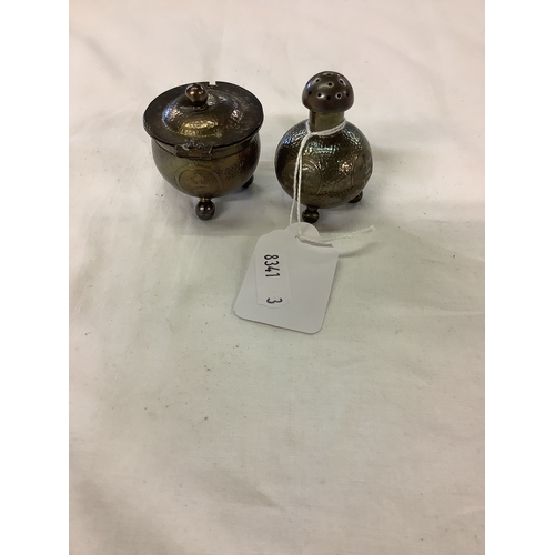 215 - An Oriental white metal salt and pepper pot