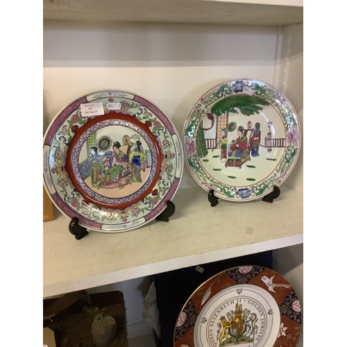 430 - Two Chinese plates with pictorial panels and famille rose borders, character marks to base