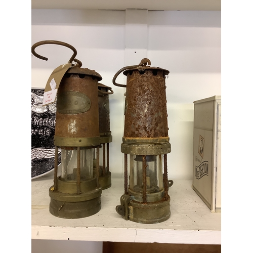 438 - Four vintage brass and steel miners lamps