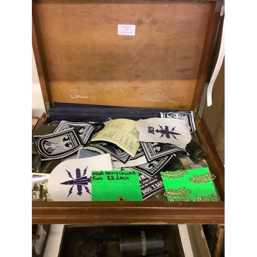 442 - A box of assorted items to include cloth and metal badges etc