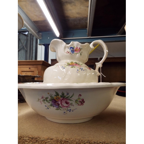 517 - A vintage wash bowl and jug with floral decoration