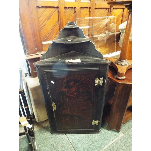 545 - A George III black lacquered chinoiserie decorated corner cabinet