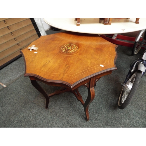 557 - A light oak scallop shaped table with satin wood inlay with under tier and shaped legs