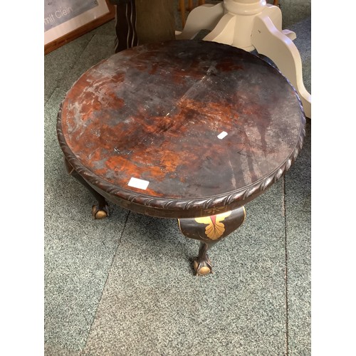 535 - An oak circular side table with embossed and gilt decorated legs