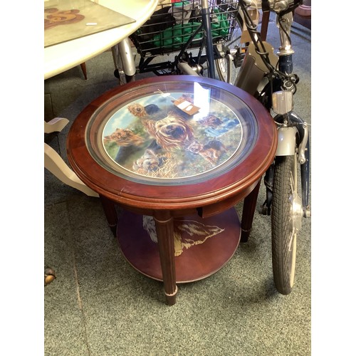 536 - A circular side table with terrier decoration