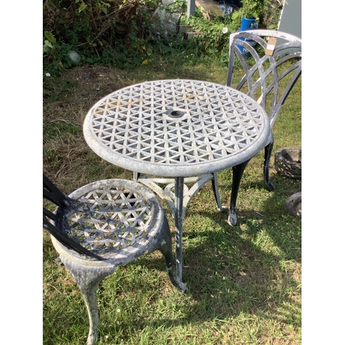 305 - A metal garden table and two chairs