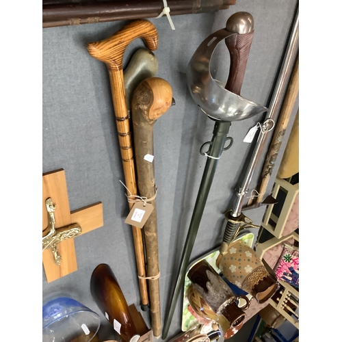 357 - Four assorted walking sticks to include a brass handled eagle