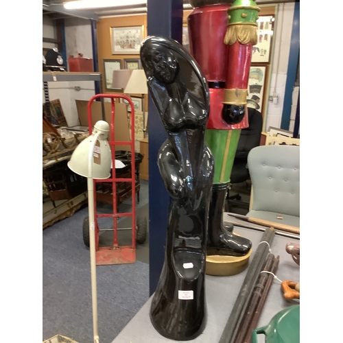 362 - A large black glazed figure of a naked female