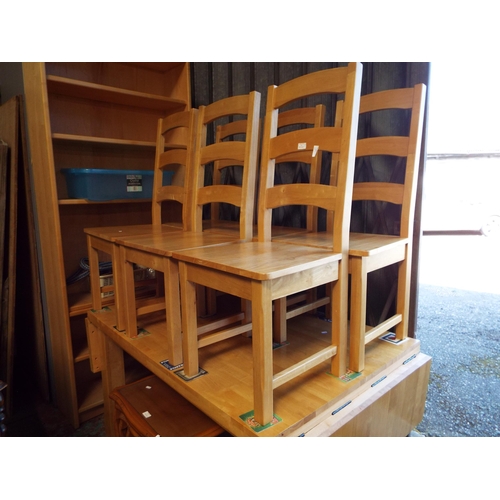 484 - A beach drop leaf oblong kitchen table and a set of six ladder back chairs