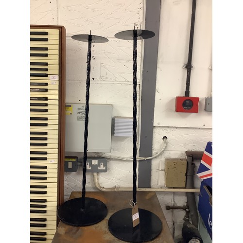 506 - Two iron candlesticks