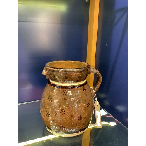 6 - An antique slip-ware jug with face decoration to spout