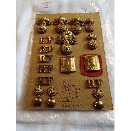 168 - A selection of Royal Fusiliers, buttons and insignia on card