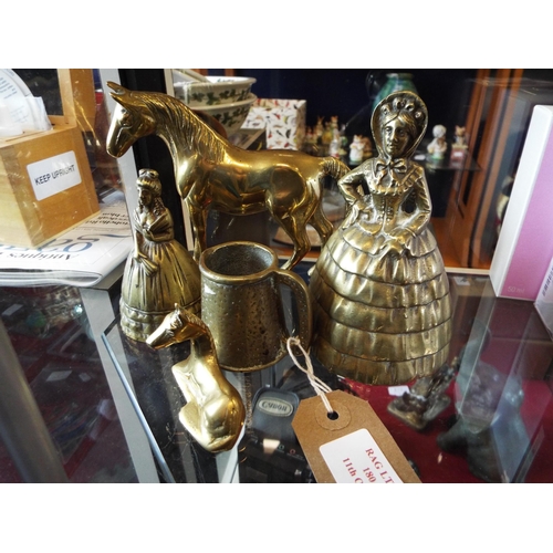 180 - A mixed selection of brass items to include lady bells, horses and jug