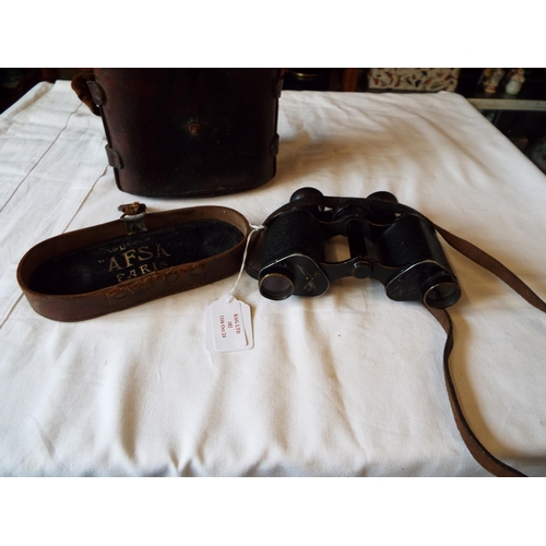 182 - A pair of WWI military binoculars housed in a leather case