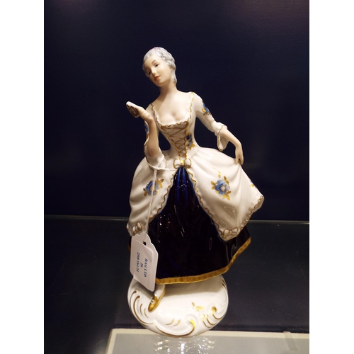 20 - A Royal Dux figurine depicting a rococo 'Lady with Fan',