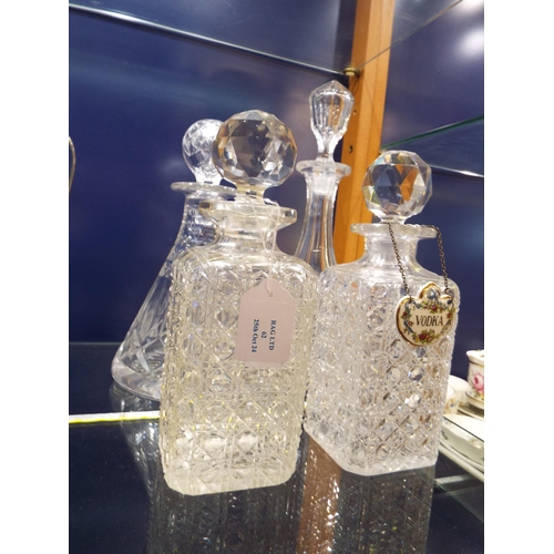 62 - Four assorted decanters to include a Ship's decanter