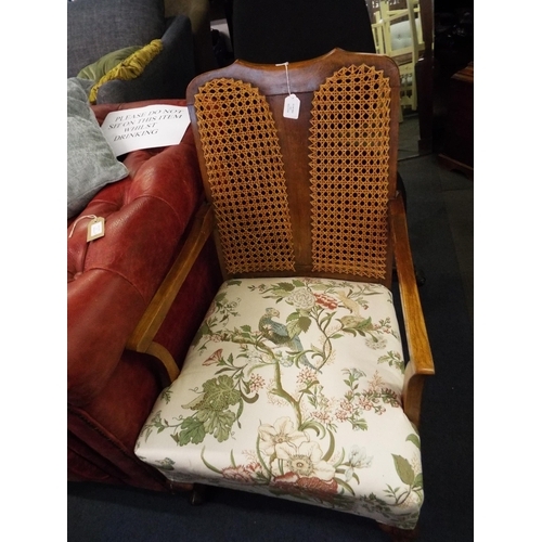 370 - A vintage bergere back panelled armchair