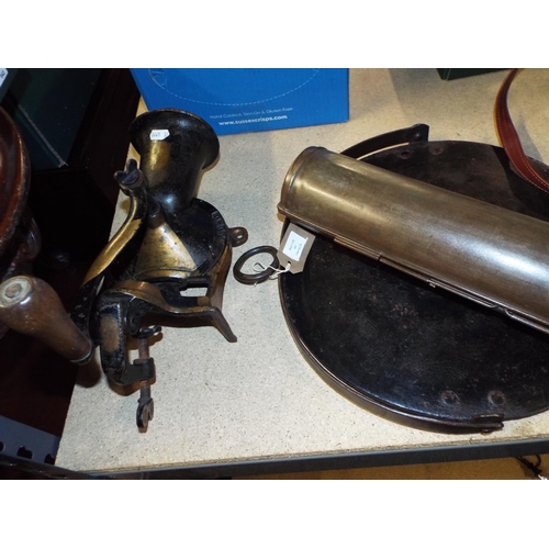 404 - A vintage kitchen grinder together with a tin pudding steamer and a cast iron griddle