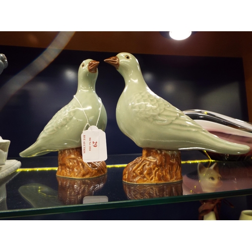 29 - A pair of Celedon green glazed birds with marks to base