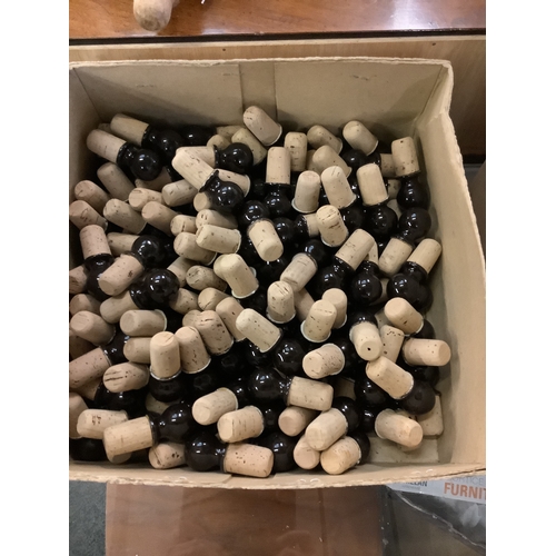 695 - A box of porcelain and cork bottle stoppers