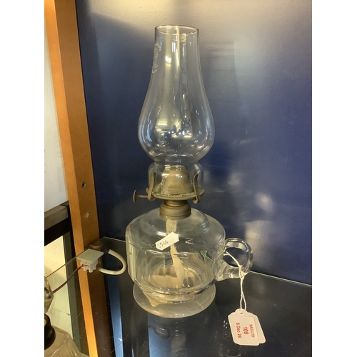 109 - A clear glass hand held oil lamp