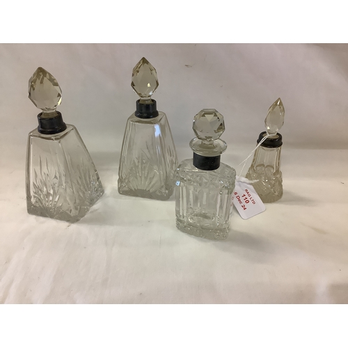 110 - Four London silver collared glass dressing table bottles