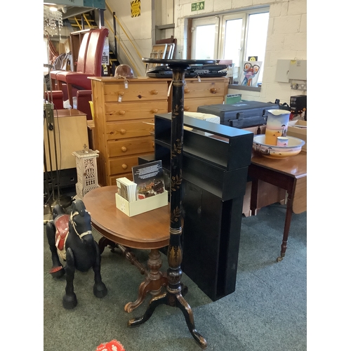 606 - A Victorian torchiere with black and gilt decoration standing on cabriole legs, 58