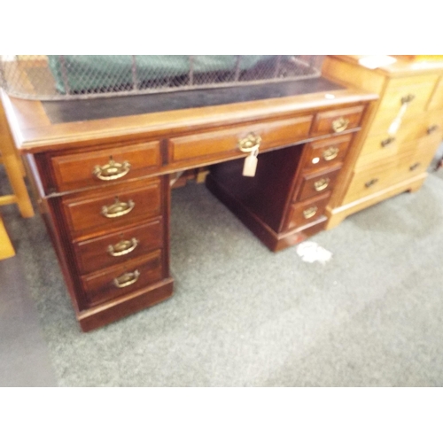 576 - A mahogany pedestal desk having leather inset with two short and one drawer and six drawers under