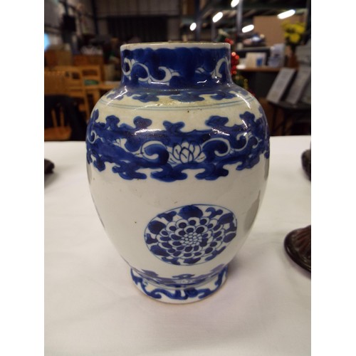 26 - Two Chinese Kangxi blue and white tea caddies having pictorial decoration resting on hardwood stands