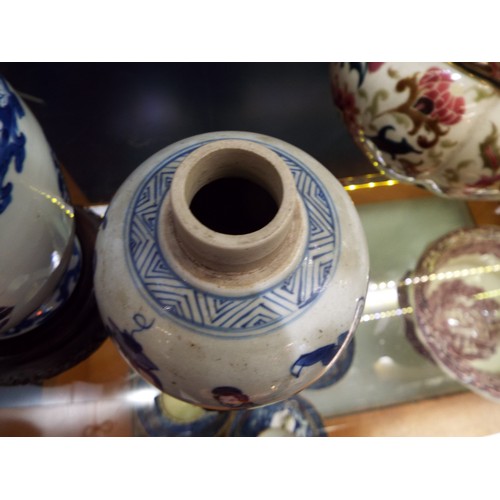 26 - Two Chinese Kangxi blue and white tea caddies having pictorial decoration resting on hardwood stands