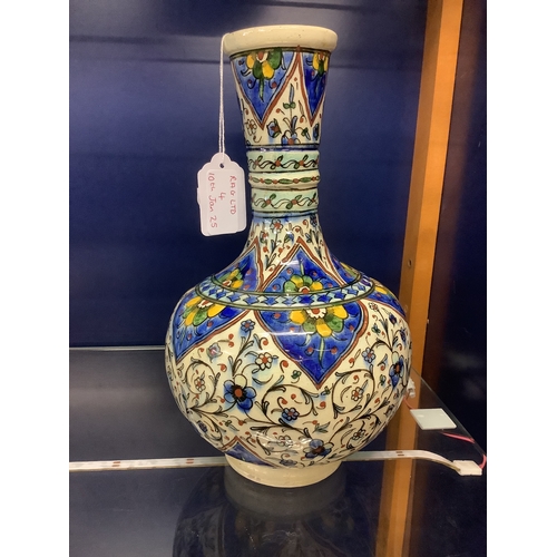 4 - A Persian style pottery vase with a blue and yellow design