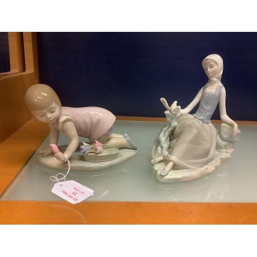 12 - Two Lladro figurines ‘girl seated with dove’ and ‘girl with flower’