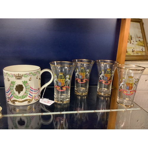 26 - A set of four Queen Elizabeth Coronation glass tumblers and Mark Phillips and Princess Anne mugs