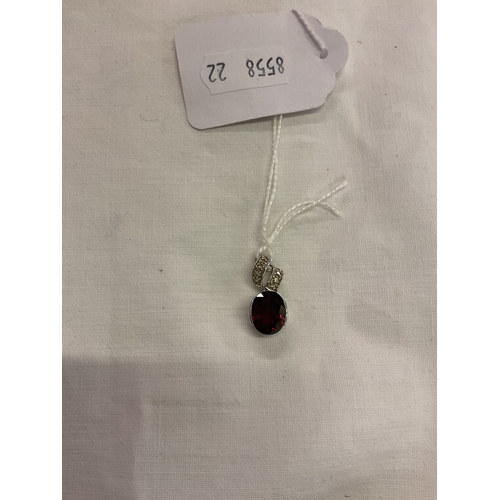 215 - A 9ct white gold pendant inset with red alma garnet and diamonds