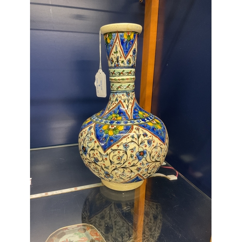 5 - A Persian style pottery vase with a blue and yellow design