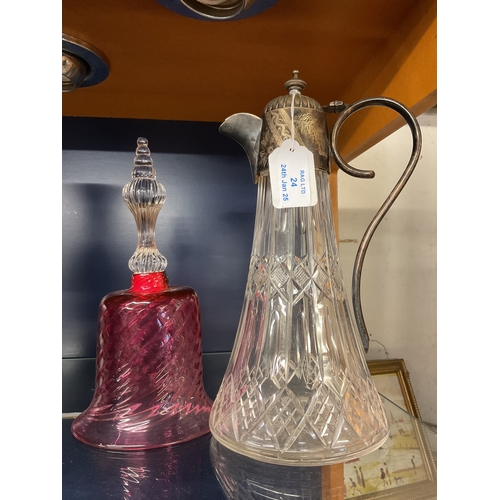 24 - A crystal cut glass and silver plated claret jug together with a vintage cranberry bell