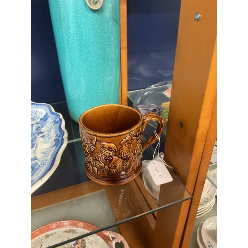 54A - Possibly a Rockingham brown glazed mug with internal frog and tavern scene decoration