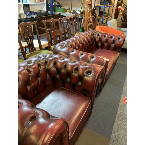 402 - An oxblood leather button back Chesterfield two seater sofa and matching chair