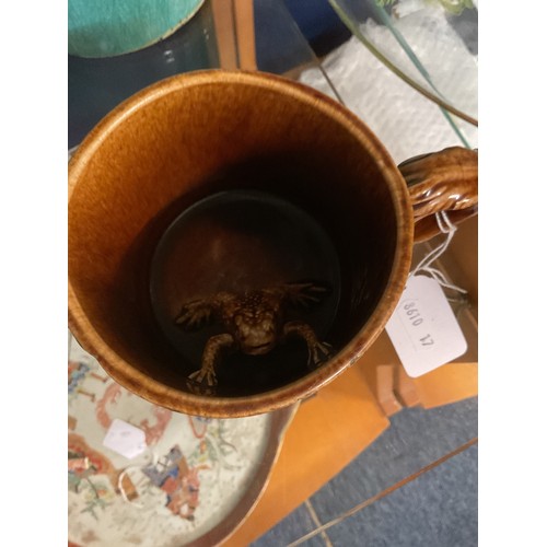 54A - Possibly a Rockingham brown glazed mug with internal frog and tavern scene decoration