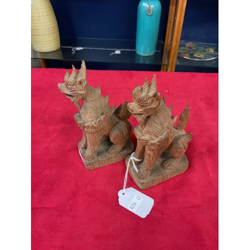 103 - A pair of Chinese carved wooden Foo dogs