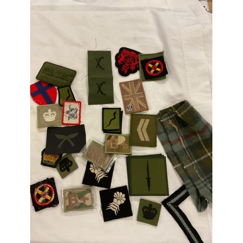 130 - A bag of assorted military cloth badges