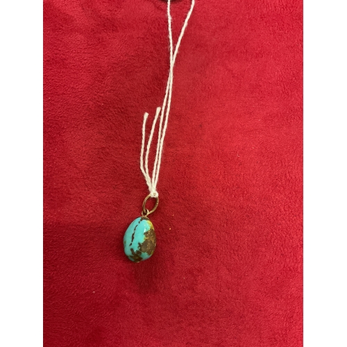 202 - A natural turquoise pendant with 9ct gold mounts