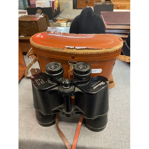 275 - A pair of leather cased binoculars