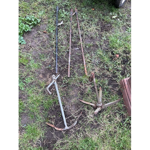 521 - Two metal boat anchors and three cast iron spindles