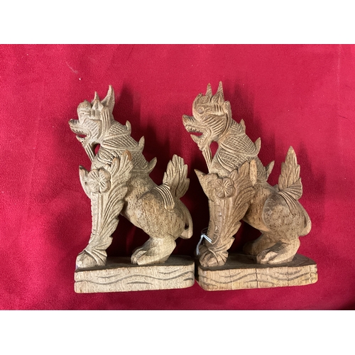 241 - A pair of Chinese carved wooden Foo dogs