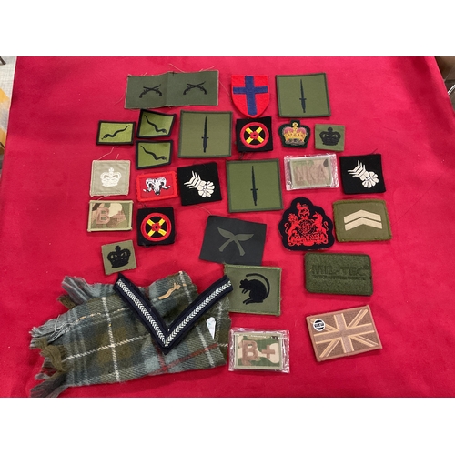 256 - A bag of assorted military cloth badges