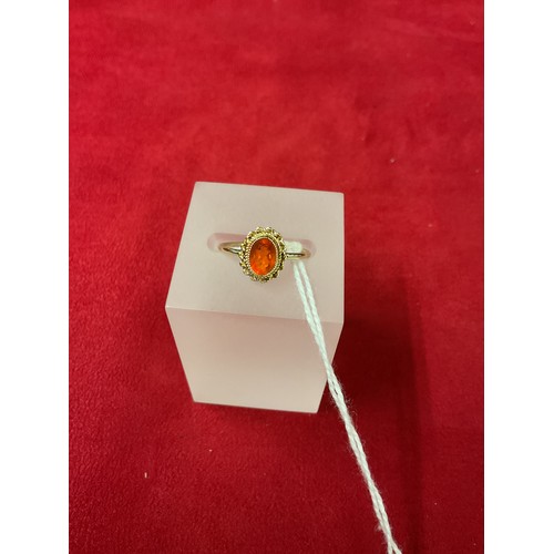 317 - A 9ct gold ring inset with oval fire opal, size L